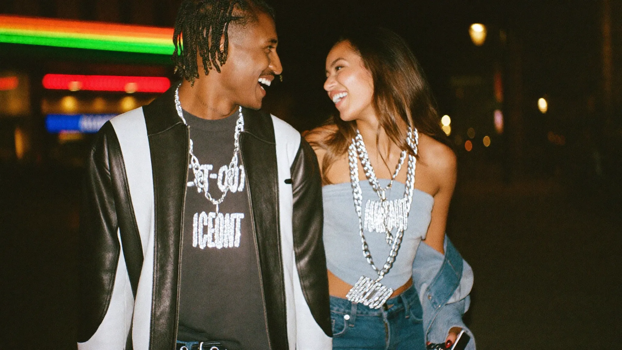 Two friends at night wearing iced-out chains and pendants
